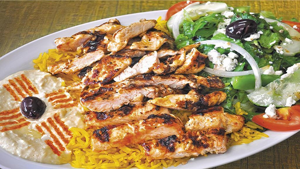 Grill Chicken Plate · Grilled seasoned chicken breast, served with hummus, salad, rice, pita, and sauce.