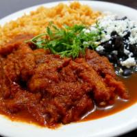 Chicharron En Salsa · Pork skin cooked in a delicious red or green sauce comes with rice, beans, and two hand-made...