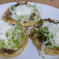 Sope (Single One) · Each thick hand-made tortilla fried and topped with brown beans, lettuce, fresh Mexican chee...