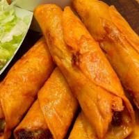 Flautas · Two crisp flour tortillas stuffed with shredded beef topped with sour cream and guacamole.