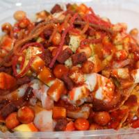 Tostilocos · Green salsa chips with Japanese peanuts, mango, cucumber, pineapple, tajin, chamoy, tajin sa...