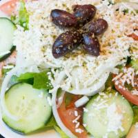 Greek Salad* · Romaine, tomatoes, cucumbers, and onions tossed in a Greek dressing, topped with feta cheese...