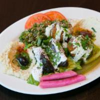 Veggie Mezza Plate* · Falafel topped with tahini, dolmas topped with tzatziki, hummus, baba ghannouj, and tabboule...