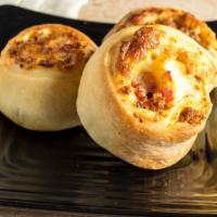 Single Pizza Roll · Ham, sausage, two types of cheese, rolled and baked in our pizza dough. Served with a side o...