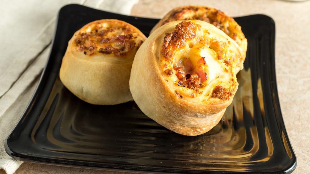 Dozen Pizza Roll Served With A Side Of Sauce · Ham, sausage, two types of cheese, rolled and baked in our pizza dough. Served with a side of sauce.