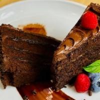 Chocolate Fudge Cake · Four layers of Belgium chocolate cake with decadent chocolate fudge frosting, decorated with...