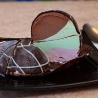Spumoni Bomba · Strawberry, pistachio and chocolate gelato all coated with chocolate and drizzled with white...