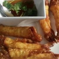 Blanket Shrimp (6) · Shrimp wrapped in egg roll wrapper lightly fried serve with house sweet and sour sauce.
