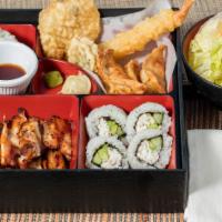 Chicken Bento · A fancy meal that includes rice, salad, chicken teriyaki, California roll, and various tempu...