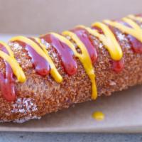 Korean Cheese Dog · Mozzarella wrapped in our mochi batter . Coated in house sugar, spicy ketchup & honey mustard