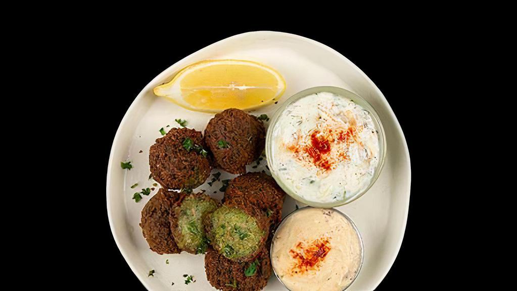 Falafel Plate · Fried Falafel Balls Served w/ Basmati Rice, Side Salad, Fresh Pita & Your Choice of Sauce.