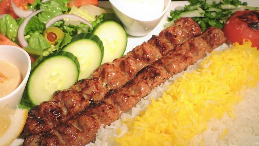 Beef Koobideh Kabob Plate · Ground Seasoned Beef Kabobs Served w/ Basmati Rice, Side Salad, Fresh Pita & Your Choice of Sauce.