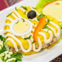 Causa Del Sabor · Mashed potatoes stuffed with layers of tuna or chicken and mild aji sauce.
