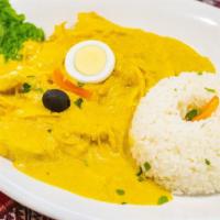 Aji De Gallina · Shredded chicken with a special cream made of milk bread, cheese and pecans. Served with ric...