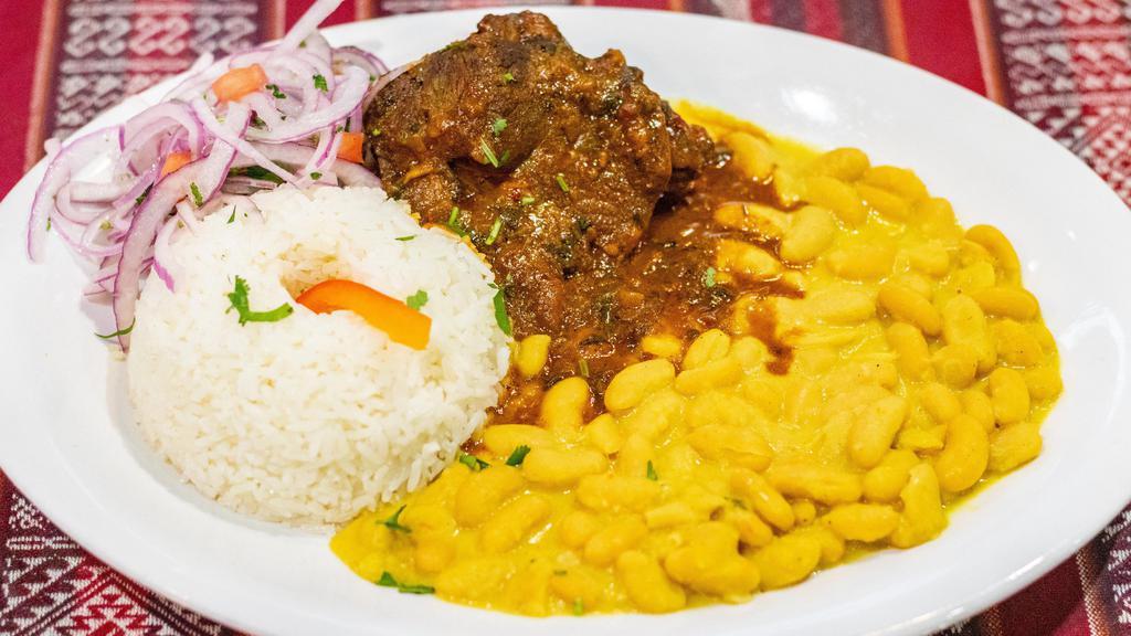 Seco Con Frijoles · Beef stewed in cilantro and Peruvian spices served with rice and beans.