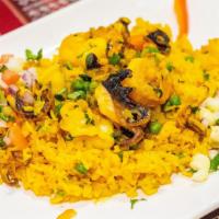 Arroz Con Mariscos · Rice cooked with tasty seafood broth. Served with octopus, squid, oysters and shrimp.