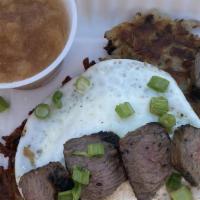 The Norma · 2 latkes topped with marinated sirloin steak and an over medium egg. Served with soup or sal...