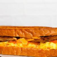 Texas Toast, Sausage, Egg, And Cheese · 2 fresh cracked cage-free scrambled eggs, melted American cheese, breakfast sausage, and Sri...