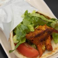 Chicken Shawarma Sandwich · With sliced spit-roasted chicken, tomatoes, onions, and garlic sauce served in pita bread.
