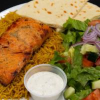 Special Salmon · Marinated grilled salmon served with rice, salad, pita bread, and garlic sauce.