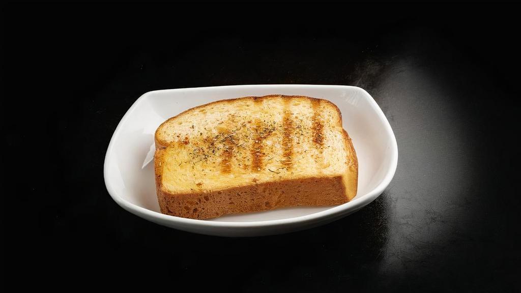 Grilled Garlic Toast · Thick-cut Texas toast, buttered and grilled, seasoned with a special garlic & herb blend