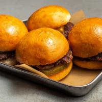 Sliders · Beef sliders with ketchup, picklese and cheese.