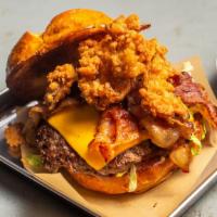 Bbq Bacon Burger · Angus beef over BBQ ranch. Topped with Cheddar cheese, smoked bacon, crispy onion strings an...