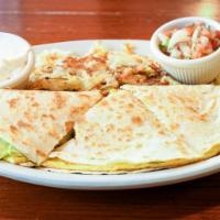 Quesadilla · Flour tortilla filled with scrambled eggs, bacon, cheddar & avocado served with salsa, sour ...