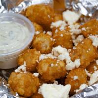 Feta & Tzatziki Tot-Box · Tater tots topped with Feta cheese and a side of Tzatziki sauce.