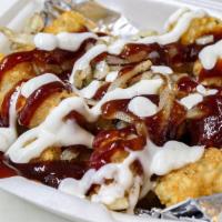 Bbq Tot-Box · Tater tots topped with sweet and savory BBQ sauce, ranch dressing and grilled onions.