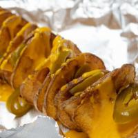 Nacho Cheese & Jalapeño Tornado Potato · A golden, crispy, deep fried spiral-cut whole potato on one skewer drizzled with nacho chees...