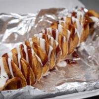 Bbq & Ranch Tornado Potato · A golden, crispy, deep fried spiral-cut whole potato on one skewer drizzled with sweet and s...