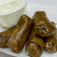 Dolmas · Rice-filled grape leaves with a combination of savory spices, served cold. Includes five dol...