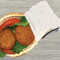 Falafel Pita · Chick peas, fava beans, spices, lettuce, tomatoes and tzatziki sauce.