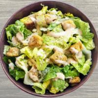 Caesar Salad · Fresh cut Romaine hearts lettuce, premium croutons, Caesar dressing and parmesan cheese.