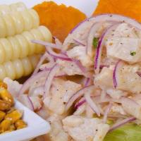 Ceviche De Pescado · Premium sea bass fish marinated in lime juice. Served with corn, yams, and fried corn.