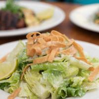 El Camino Caesar Salad · Organic romaine, avocado-caesar dressing, cotija cheese, house made tortilla strips