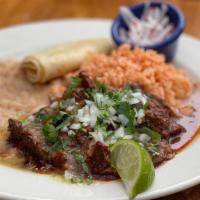 Birria · All-Natural beef slow roasted in acho chile-tomato finished with tomatillos, onion, radish a...