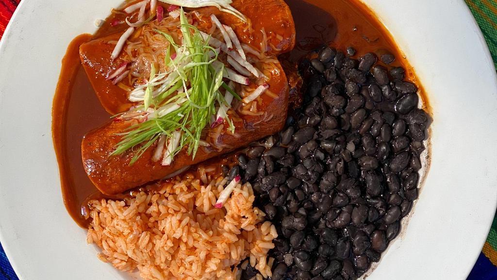 Mole Coloradito · Classic red mole with a spicy kick. Two enchiladas with your choice of filling served with Spanish rice & vegetarian black beans.