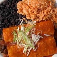Caldillo De Jitomate · Chipotle tomato sauce. Two enchiladas with your choice of filling served with Spanish rice &...