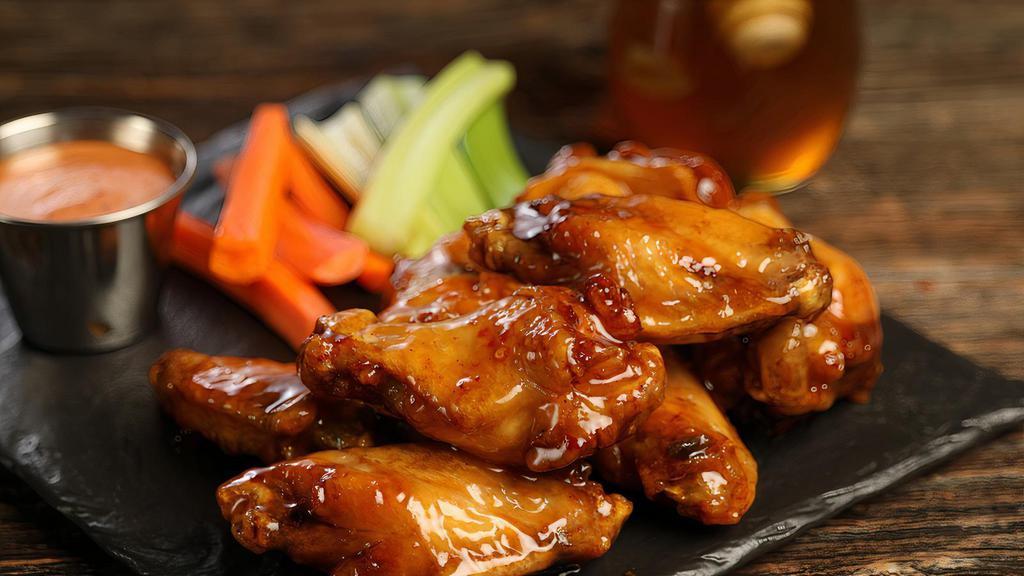 Hot Honey · 8 hot honey wings (medium heat), served with carrots & celery and a choice of blue cheese, classic ranch, or Sriracha ranch for dipping