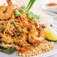 Pad Thai  · Known as one of the most popular Thai noodle dishes, our version features stir-fried thin ri...