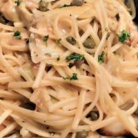 Scampi Siena · Linguine simmered with pan seared prawns, capers, roasted garlic and artichoke hearts in ali...