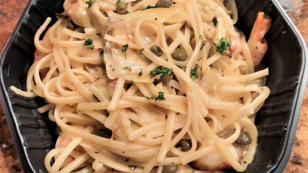 Scampi Siena · Linguine simmered with pan seared prawns, capers, roasted garlic and artichoke hearts in alight lemon butter chardonnay sauce