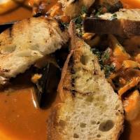Cioppino · Prawn, mahi mahi, salmon, mussels, clams, and calamari simmered in a fresh tomato wine sauce...