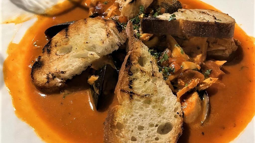 Cioppino · Prawn, mahi mahi, salmon, mussels, clams, and calamari simmered in a fresh tomato wine sauce. Served with grilled ciabatta bread.