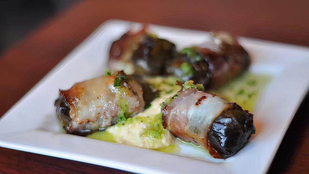Traditional Dolmades Wrapped In Bacon · Rice stuffed grape leaves (dolmas) wrapped in bacon.