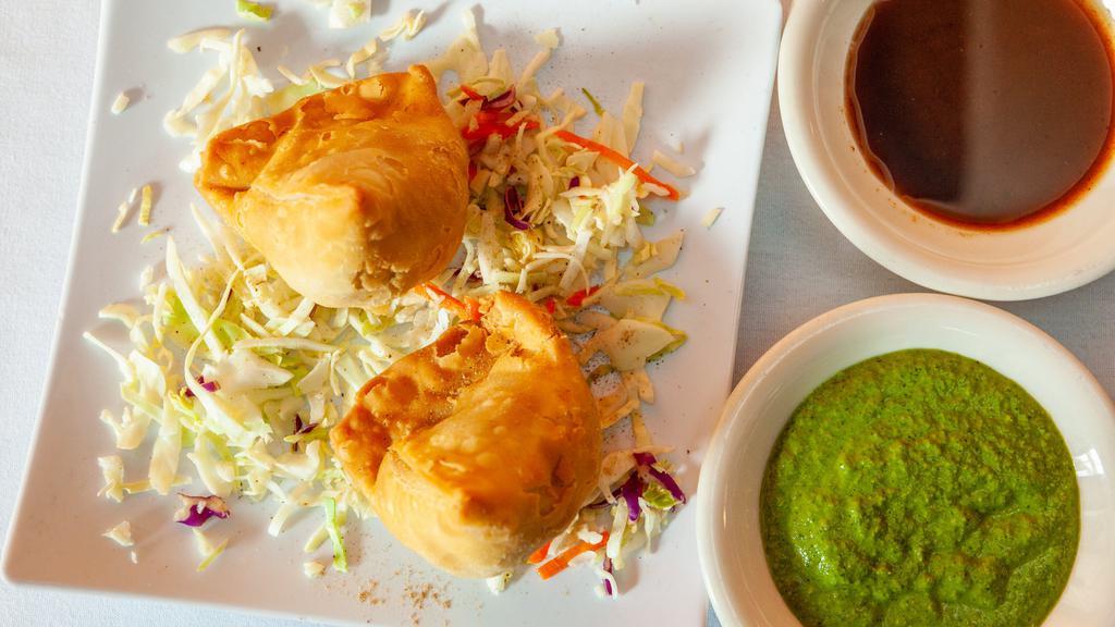 Samosa · Deep-fried crispy pastry of all-purpose dough filled with the stuffing made of mashed potato and peas and served with tamarind chutney.