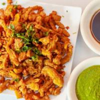 Veg Pakora · Sliced vegetables and onions dusted in gram flour and deep-fried to crisp.
