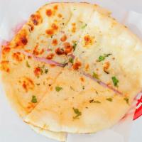 Garlic Naan · An Indian bread made of white flour and layered with garlic pieces. When cooked in tradition...
